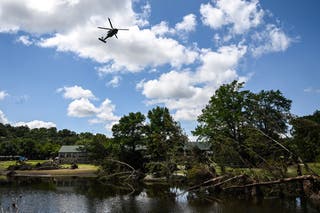 A helicopter flies above Camp Mystic along the Guadalupe River in Hunt, Texas. At least 27 children and staffers from the all-girls summer camp were killed by the floods